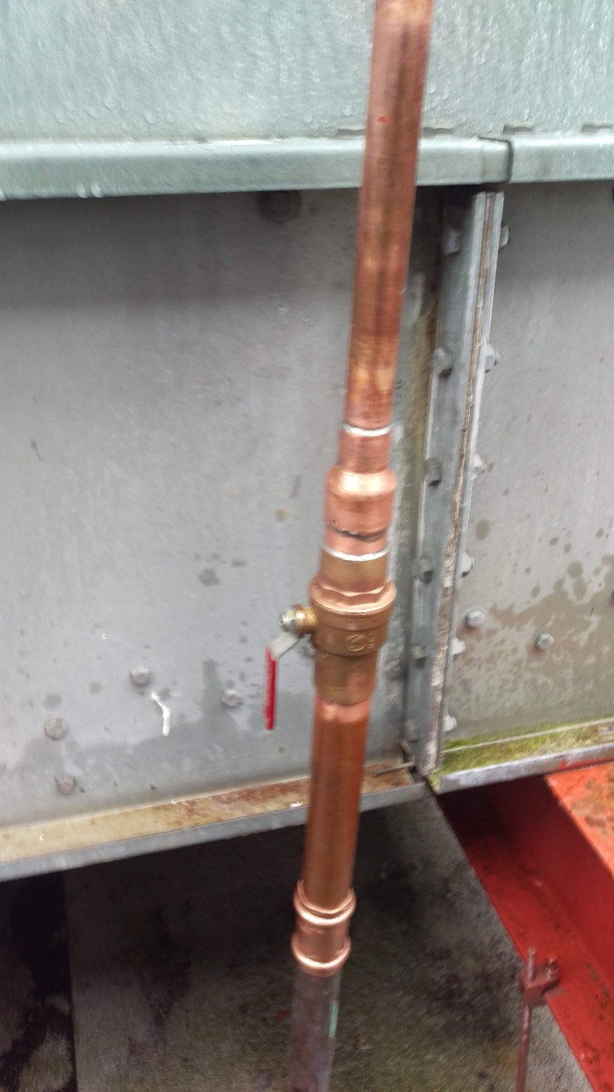 Copper makeup water piping with a manual ball valve for isolating the supply during maintenance.
